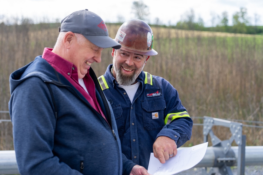 Top Bead millwright goes over plans with client on jobsite