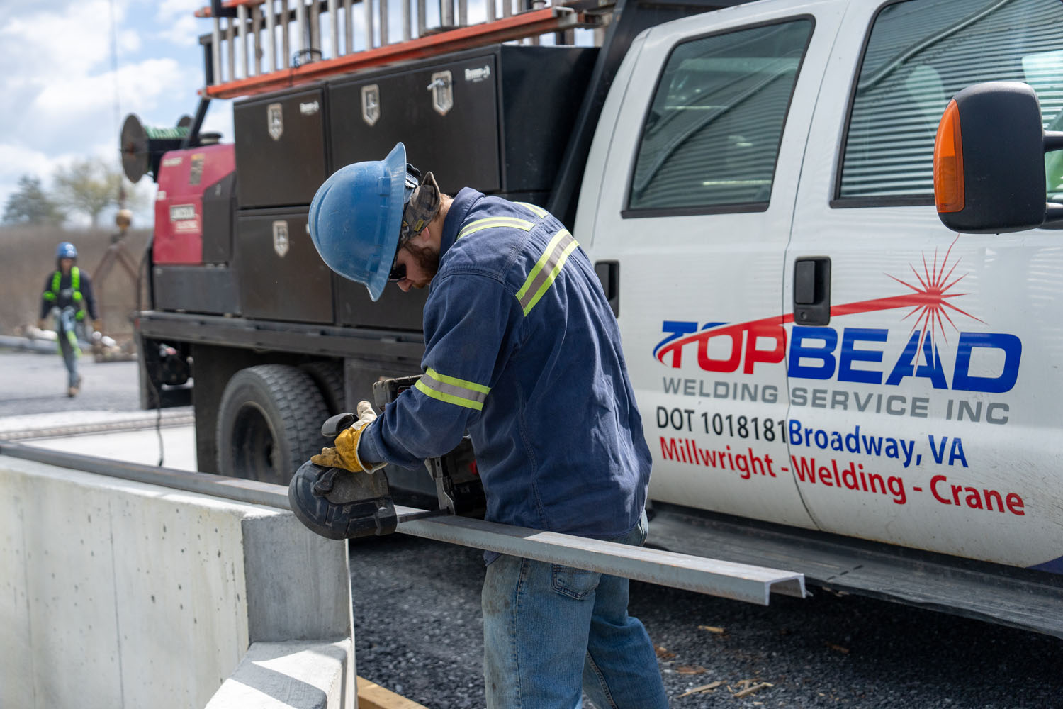 Millwright cutting a steel beam