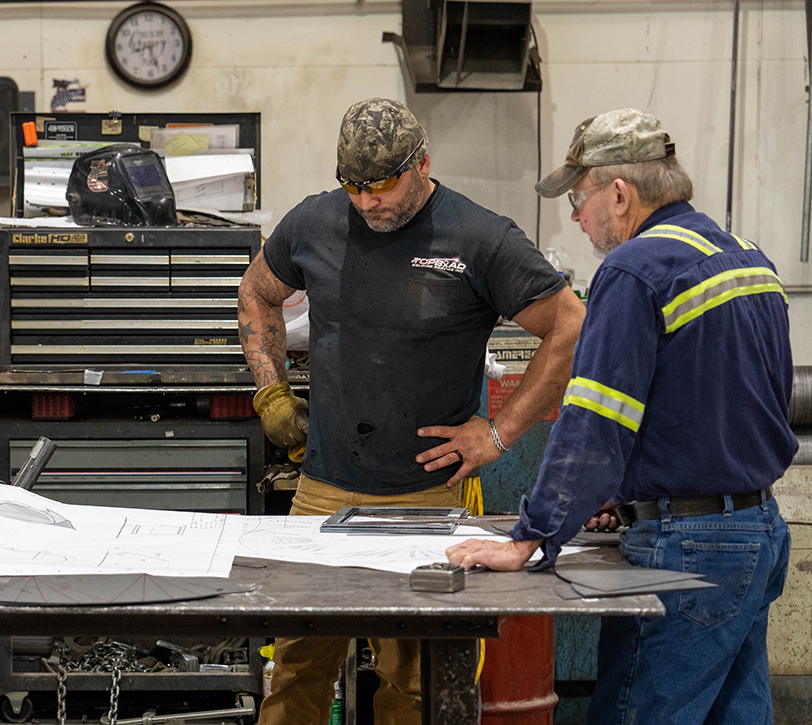 Top Bead Metalworkers looking at project plans together