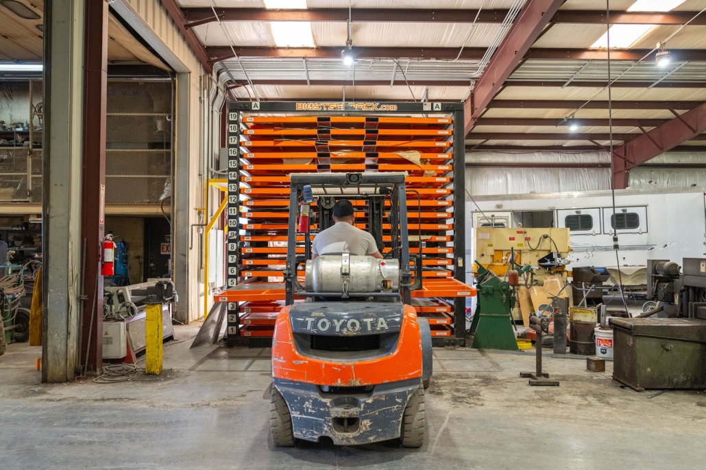 Shop worker driving a forklift