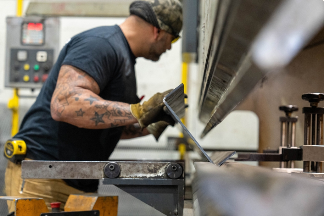 fabricator working with piece of metal