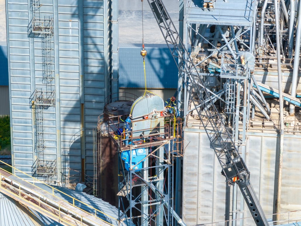 drone shot of crane lifting machinery