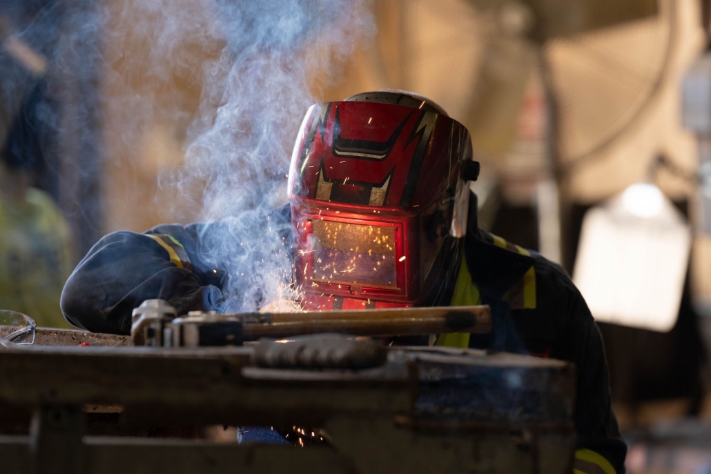 closeup of welder welding with mask on